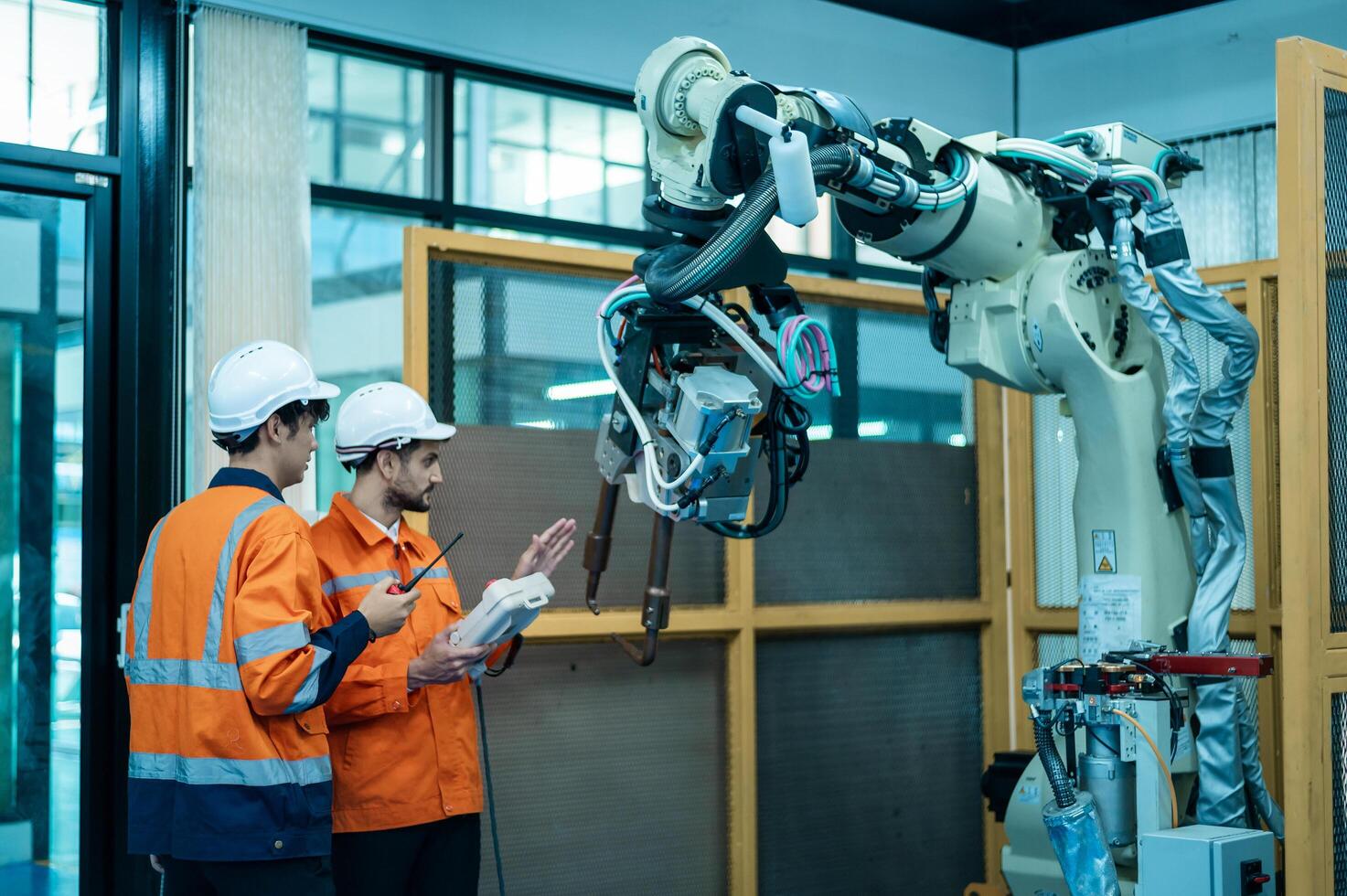 A group of Robotics engineers working with Programming and Manipulating Robot Hand, Industrial Robotics Design, High Tech Facility, Modern Machine Learning. Mass Production Automatics. photo