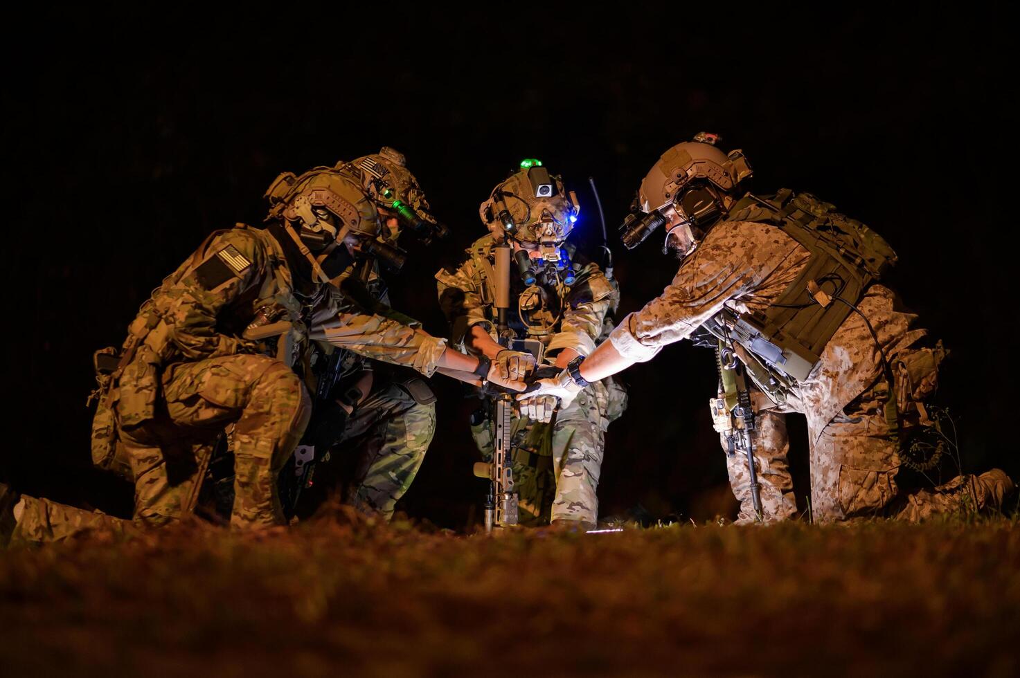 Soldiers in camouflage uniforms aiming with their rifles ready to fire during Military Operation at night, soldiers training in a military operation photo