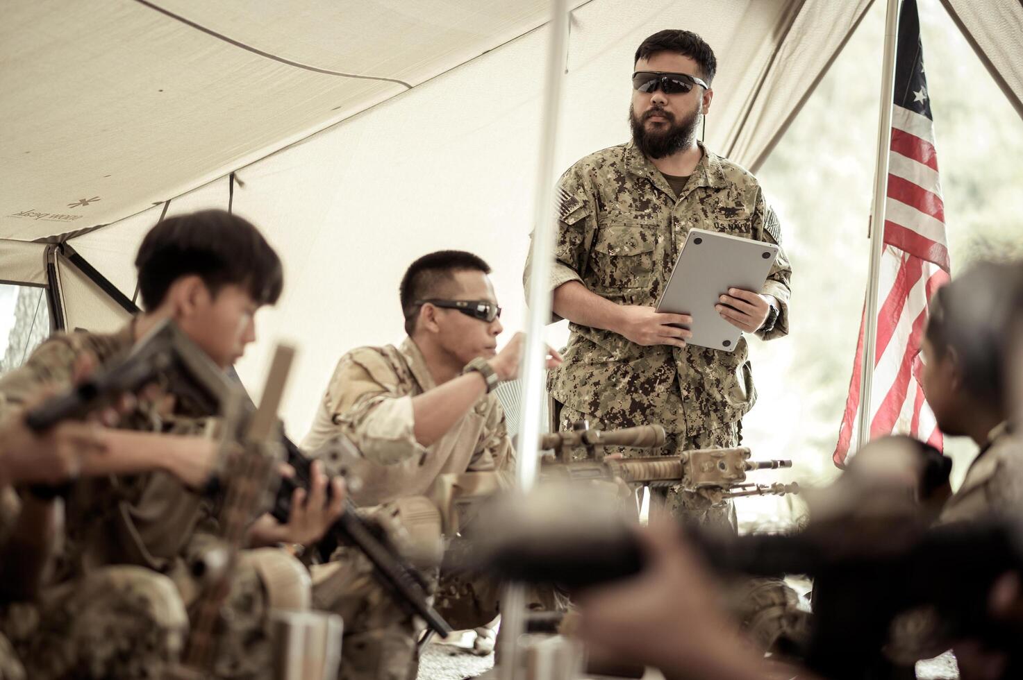 Soldiers in camouflage uniforms planning on operation in the camp photo