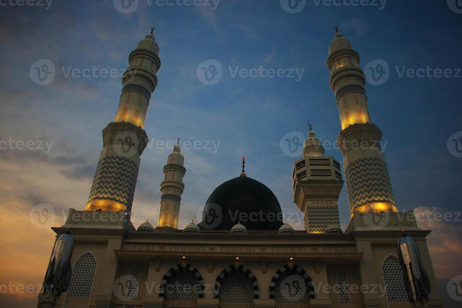 mosque at the evening and drammatic sky background photo