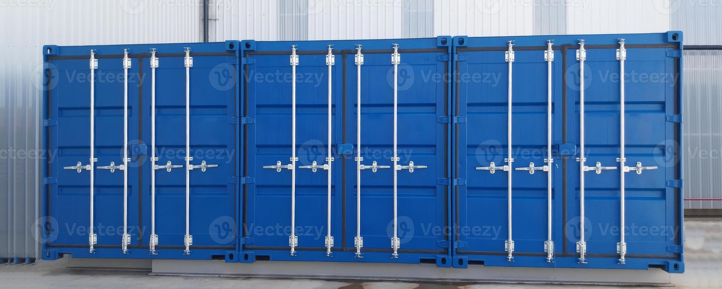 Three blue shipping containers with closed doors. photo