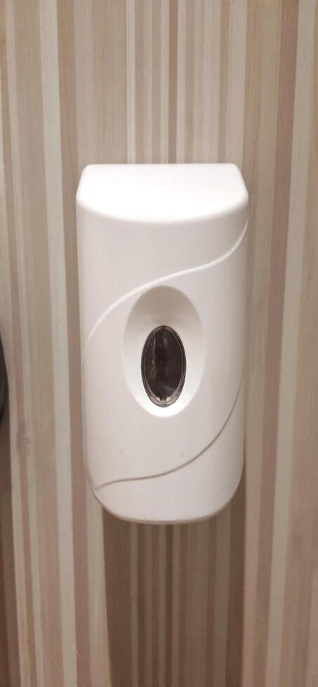 Automatic soap dispenser or hand sanitizer machine to clean bacteria and hygiene hands in toilet photo