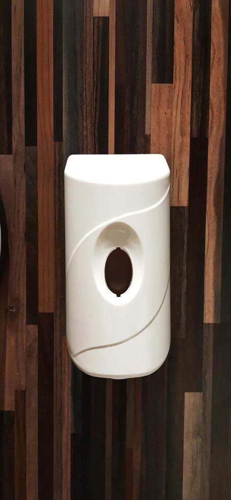 Automatic soap dispenser or hand sanitizer machine to clean bacteria and hygiene hands in toilet photo