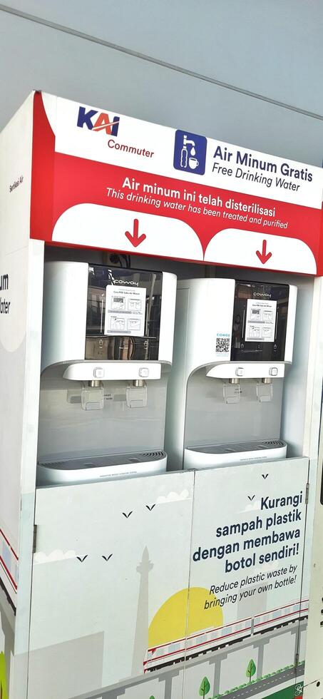 Free drinking water machine for public service at train station Bekasi. West Java, Indonesia - April 8 2024 photo