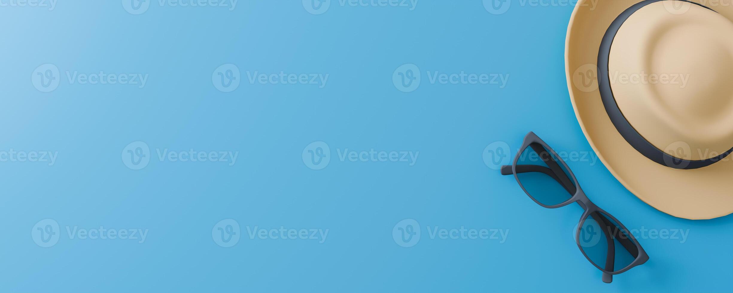 A hat and a pair of sunglasses are on a blue background. with space copy photo