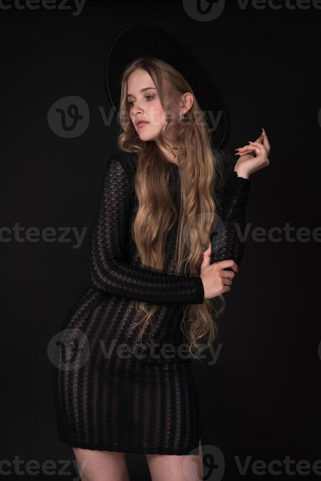 Portrait of shy blonde looking away, shyly raising one arm bent at elbow, supporting it with other photo