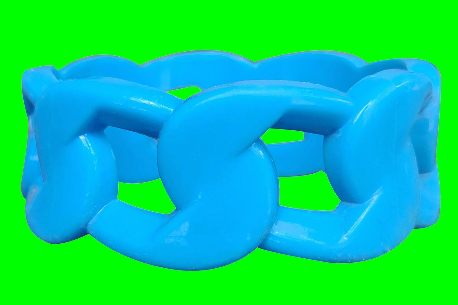 Used plastic bracelet from a toy with a light green background texture photo