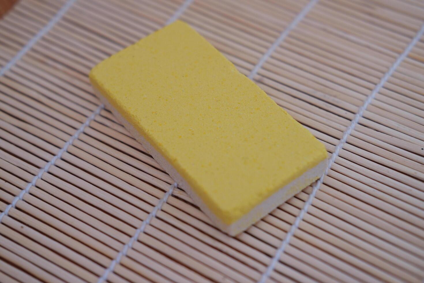 yellow snacks on a bamboo mat, close-up, selective focus photo