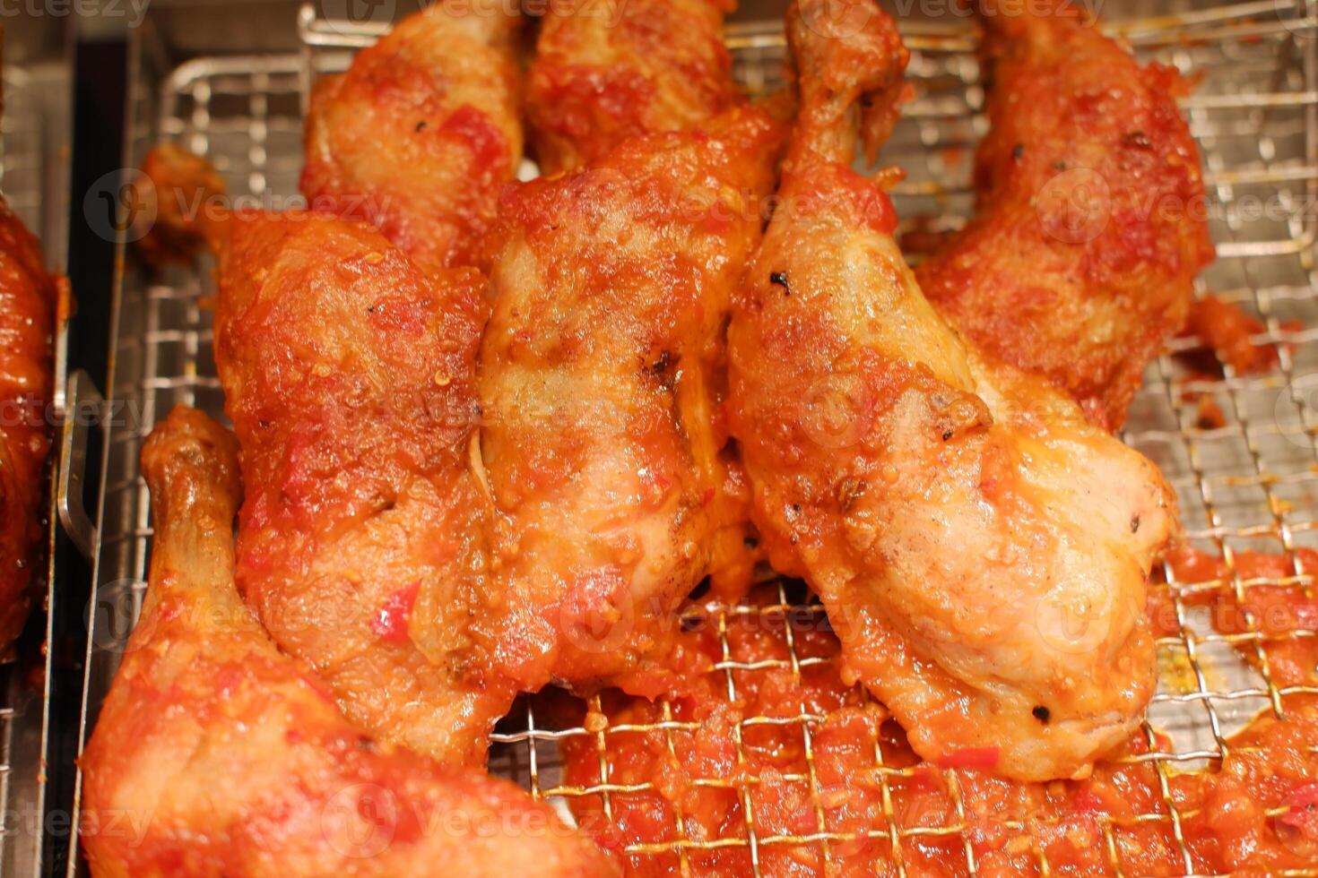 Fried chicken wings on the stove in the market photo