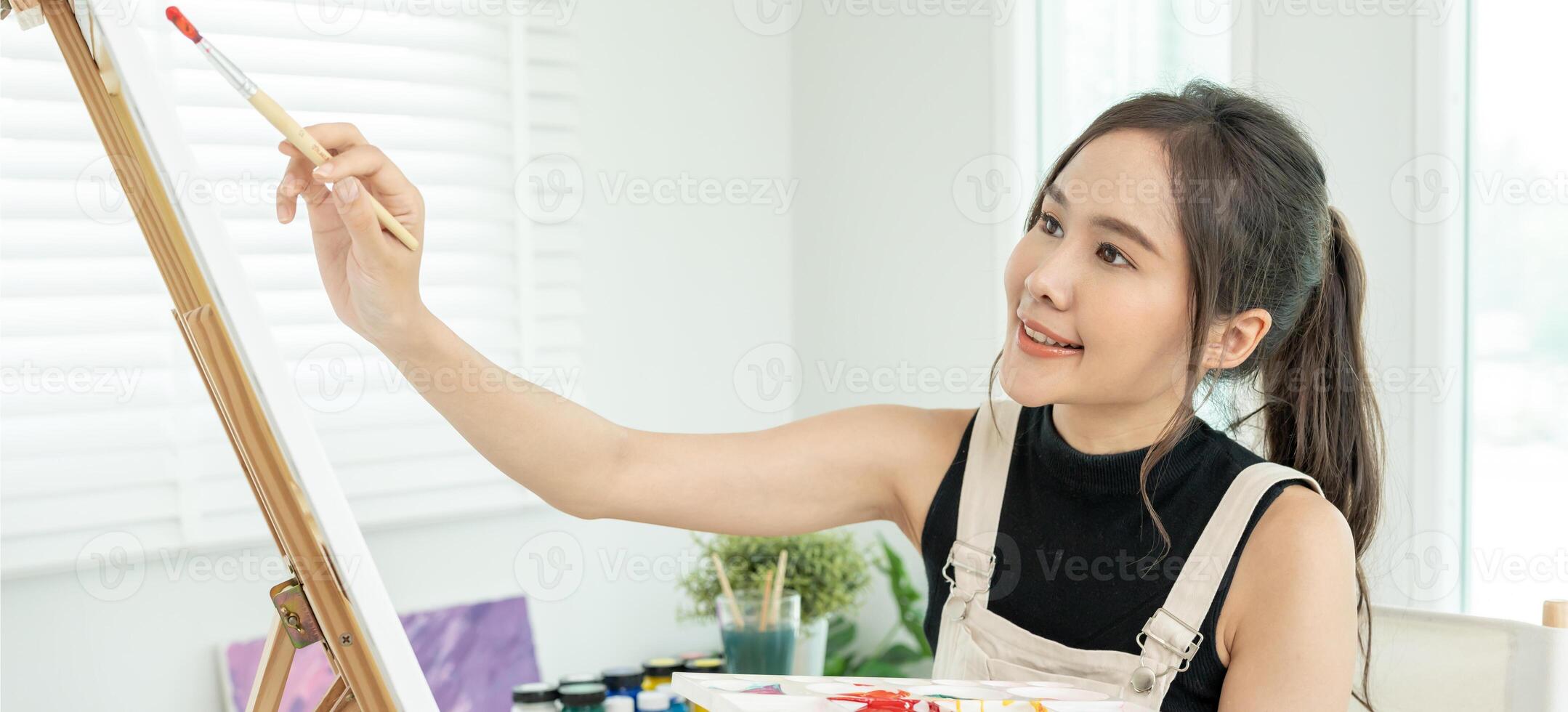 female hobbies about artist and use paintbrush in abstract art for create masterpiece. painter paint with watercolors or oil in studio house. enjoy painting as hobby, recreation, inspiration photo