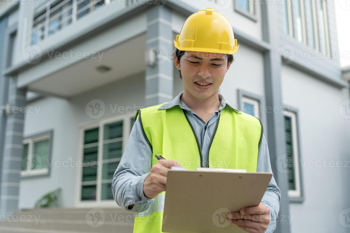 inspector or engineer is inspecting construction and quality assurance new house using a checklist. Engineers or architects or contactor work to build the house before handing it over to the homeowner photo