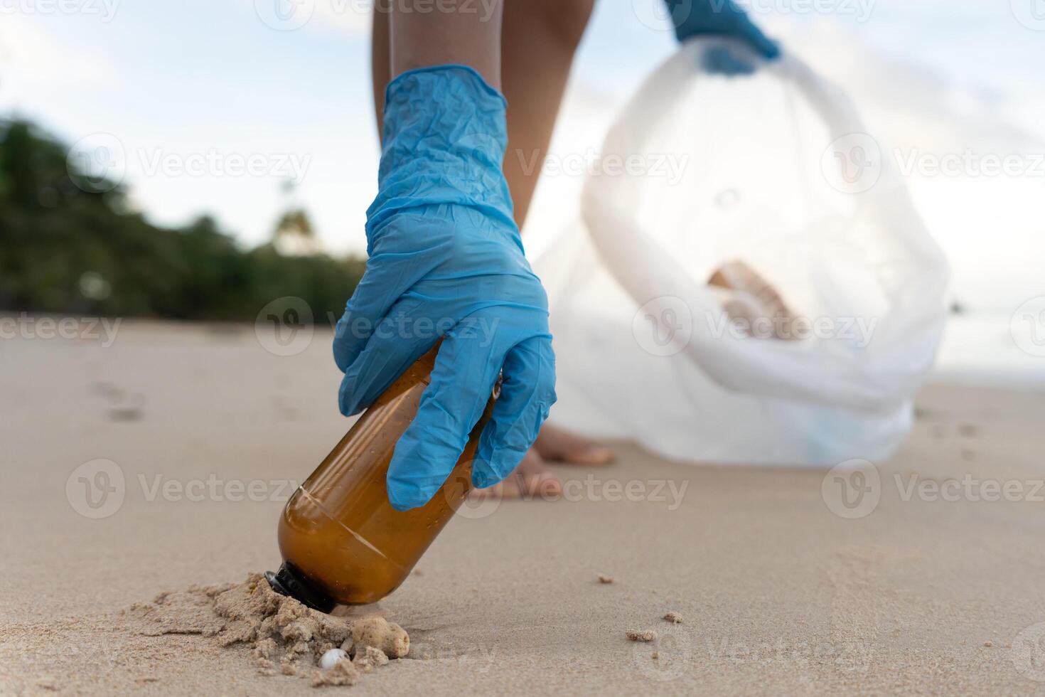 Save ocean. Volunteer pick up trash garbage at the beach and plastic bottles are difficult decompose prevent harm aquatic life. Earth, Environment, Greening planet, reduce global warming, Save world photo