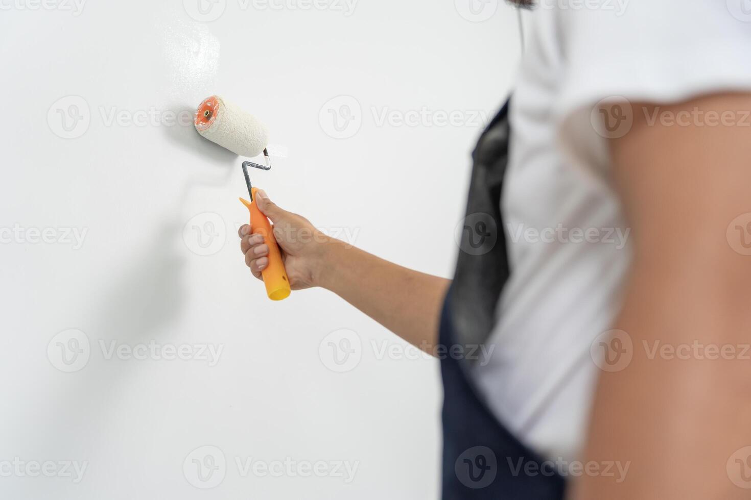 painter man, brush in hand for products to restore and paint the wall, indoor the building site of a house, wall during painting, renovation, painting, contractor, Architect, construction worker photo