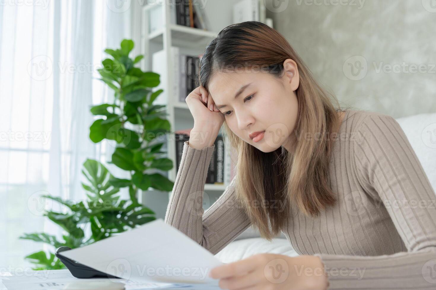 Debt shopping, Stressed and headache asian woman with large bills or invoices no money to pay, shortage, Financial problems, mortgage, loan, bankruptcy, bankrupt, poor, empty wallet, overdue photo
