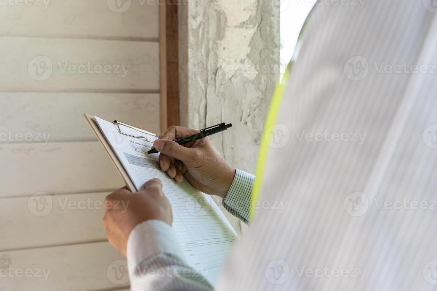 inspector or engineer is inspecting construction and quality assurance new house using a checklist. Engineers or architects or contactor work to build the house before handing it over to the homeowner photo