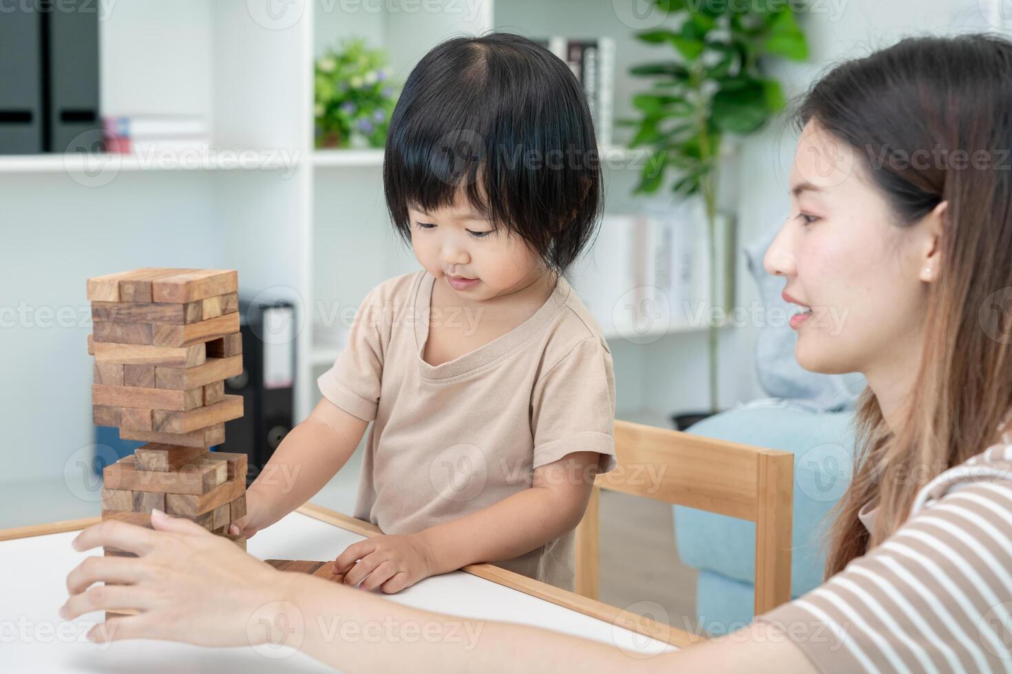 Happy Asia mother play and learn toy blocks with the little girl. Funny family is happy and excited in the house. Mother and daughter having fun spending time together. Holiday, Activity, development photo
