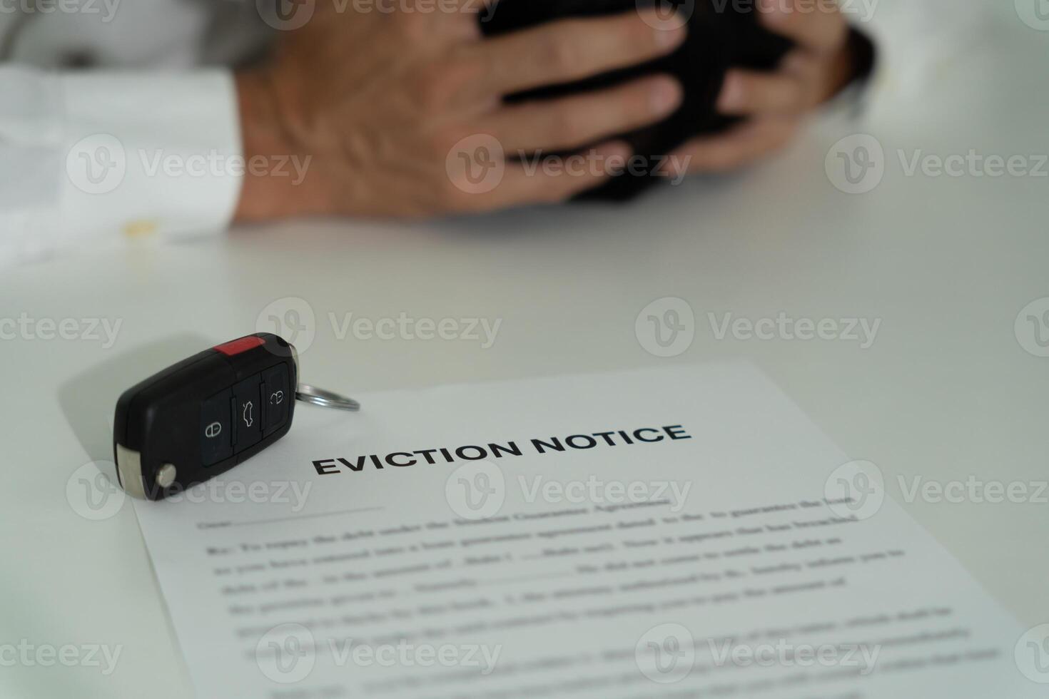 Business man is stressed due to imminent seizure of car debts, financial problems, loans, guarantees document with the text eviction notice, debt, property, loan, agent, bankruptcy photo