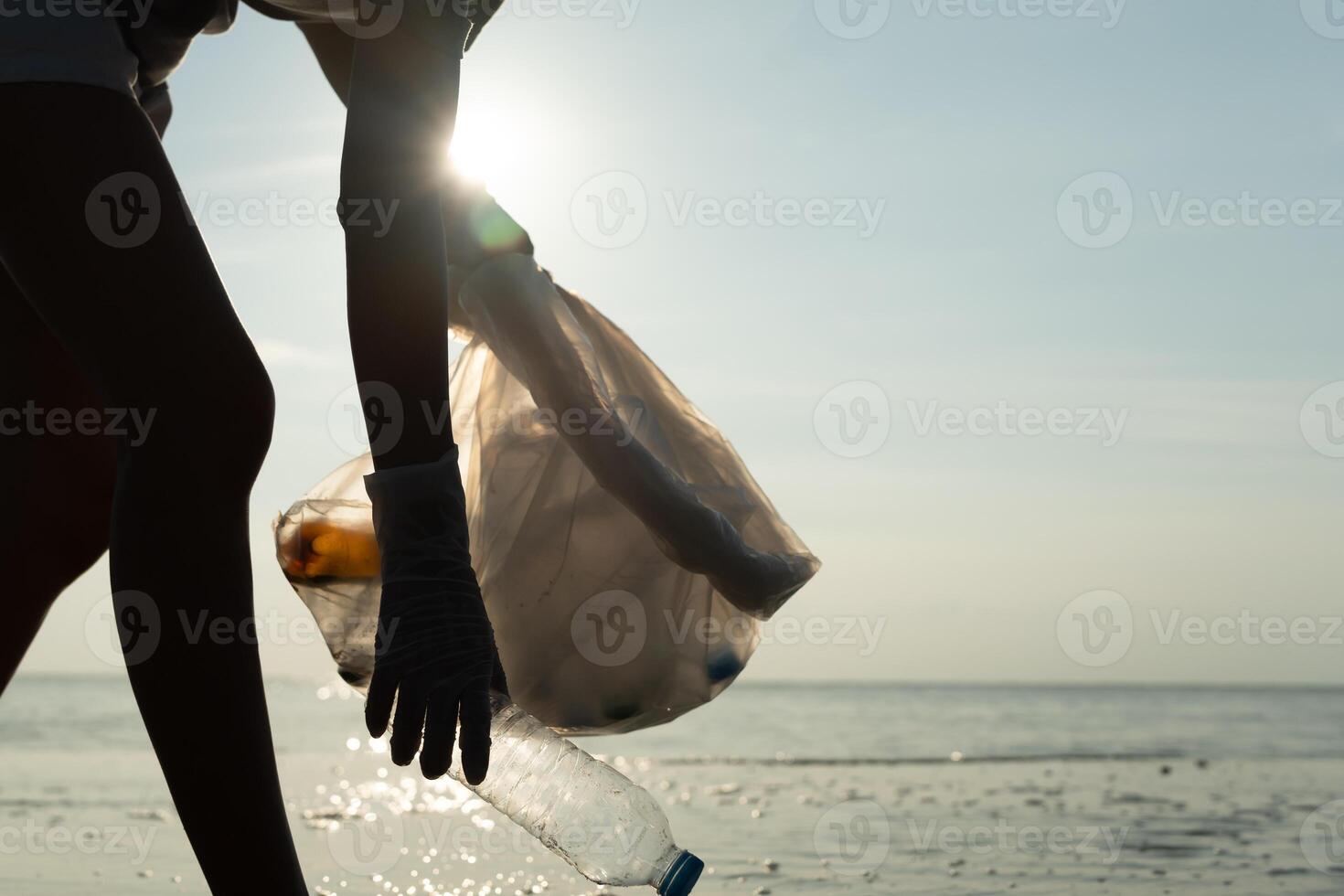 Save water. Volunteer pick up trash garbage at the beach and plastic bottles are difficult decompose prevent harm aquatic life. Earth, Environment, Greening planet, reduce global warming, Save world photo