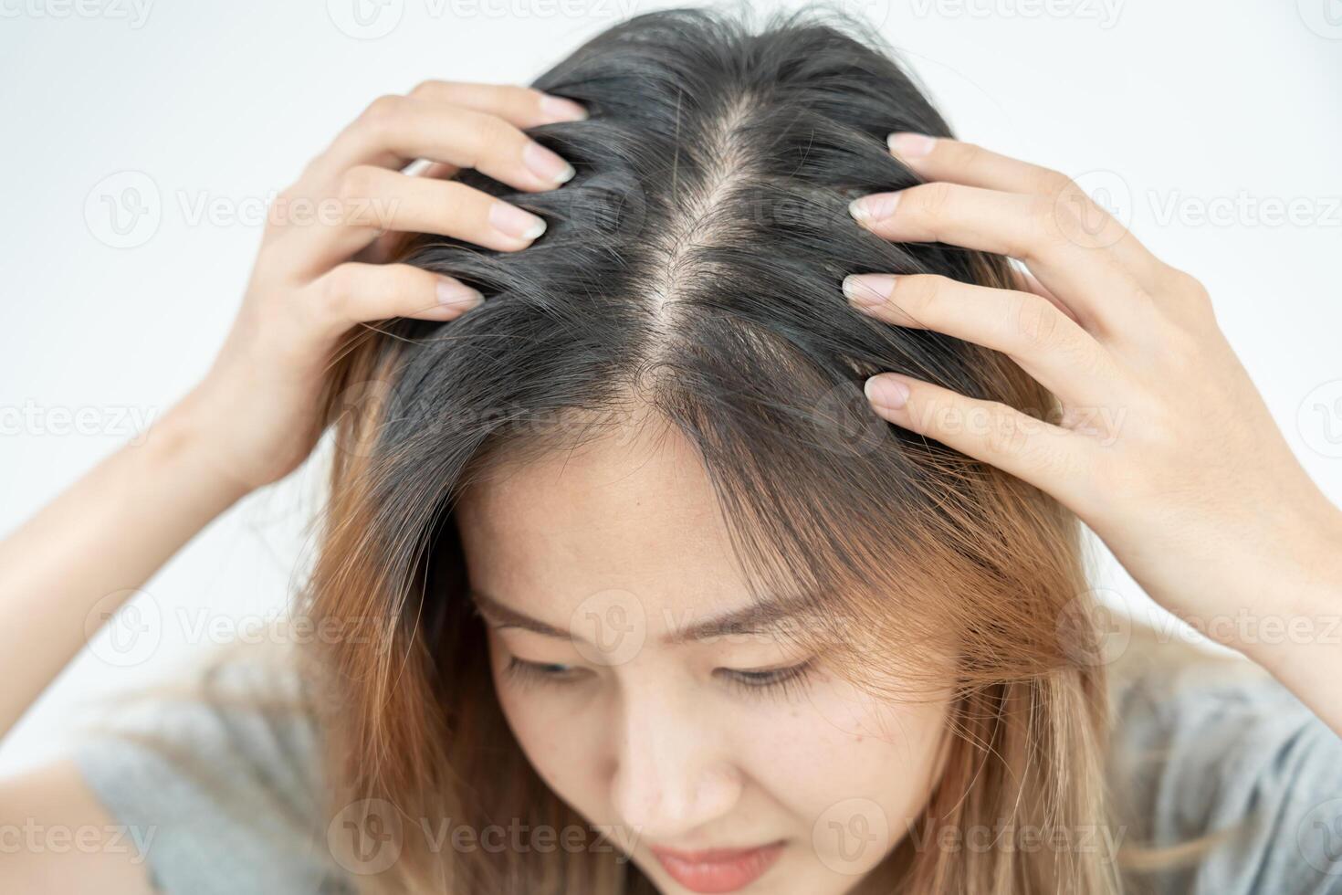 Asian woman very sad and upset looking at damaged hair, hair loss, hair thinning problem, vitamin deficiency, baldness, postpartum, biotin, zinc, menstrual or endocrine disorders, hormonal imbalance photo