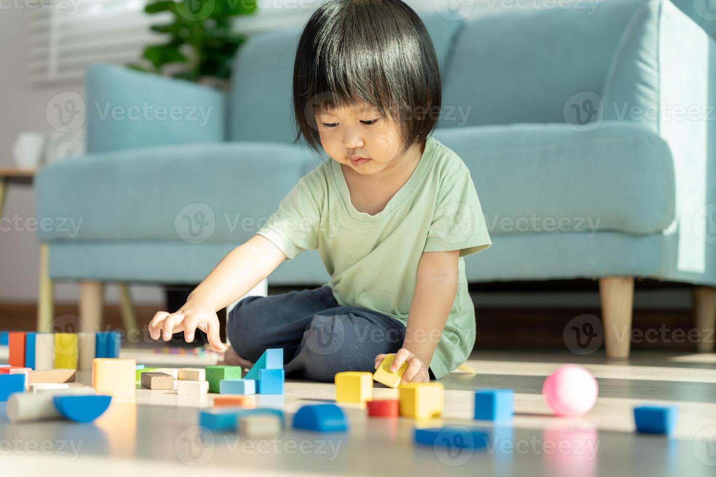 Happy Asian child playing and learning toy blocks. children are very happy and excited at home. child have a great time playing, activities, development, attention deficit hyperactivity disorder photo