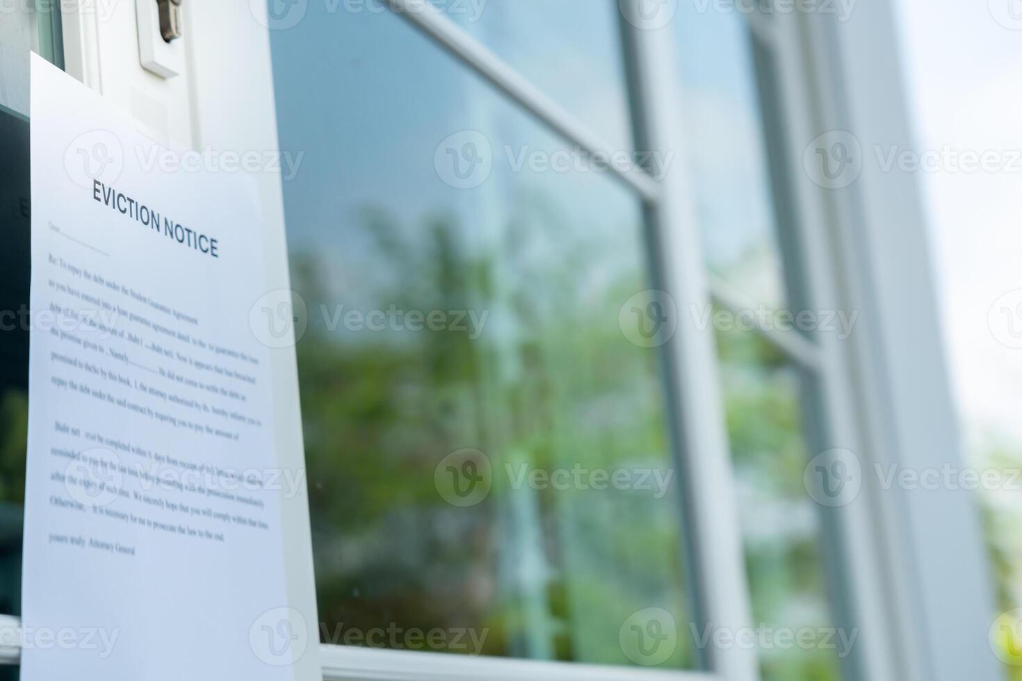 document with the text eviction notice, Civil servant sticks a notice of eviction of the tenants hangs on the door of the house, debt, property, loan, agent, bankruptcy, dispossess, problem photo