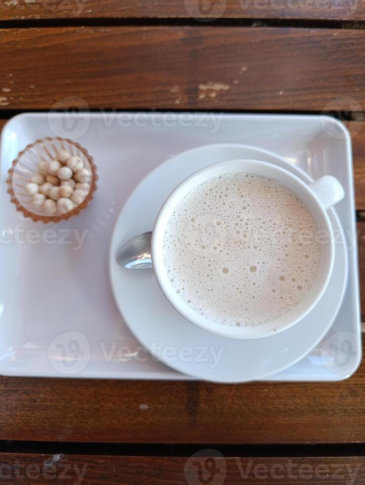 A cup of salep on the table photo