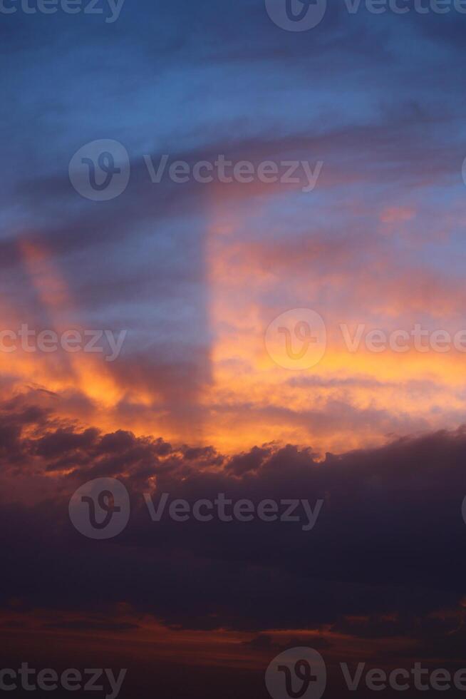 a sunset sky with clouds and a purple sky with a few clouds. photo