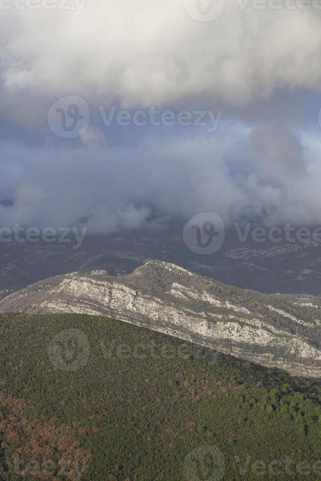 Spring in the mountains, beautiful mountain landscape. View of the mountain range and green trees. Summer, autumn and winter. Budva, Montenegro. Europe. Background. For text. Banner. Postcard. photo