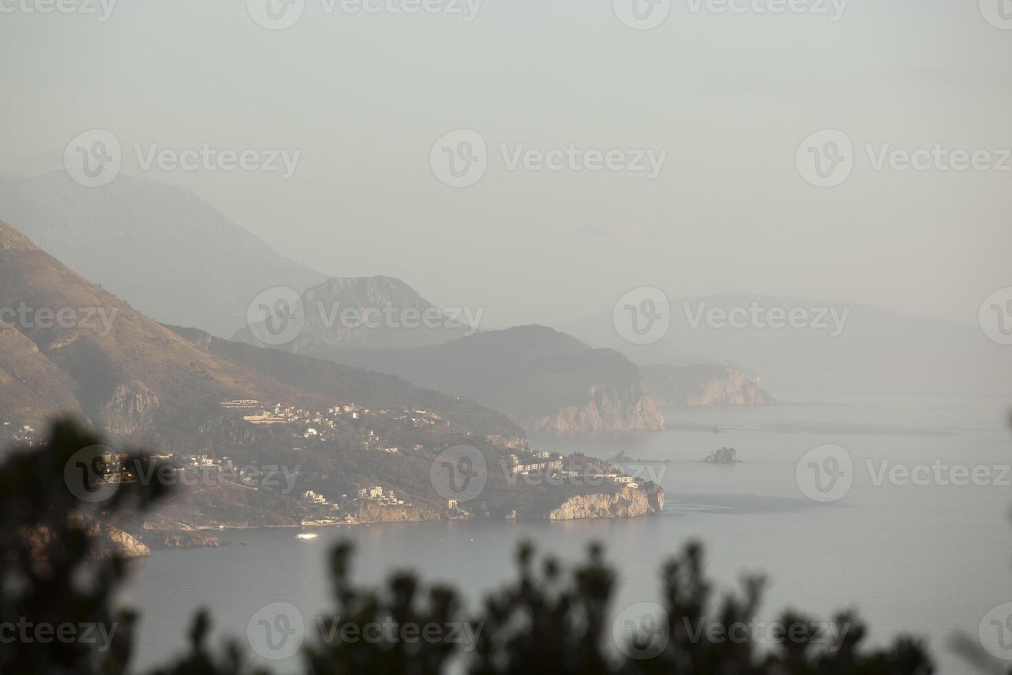Spring in the mountains, beautiful mountain landscape. View of a mountain range and green trees. Landscape in the haze. Sands of the Sahara. Budva, Montenegro. Europe. Horizontal photo