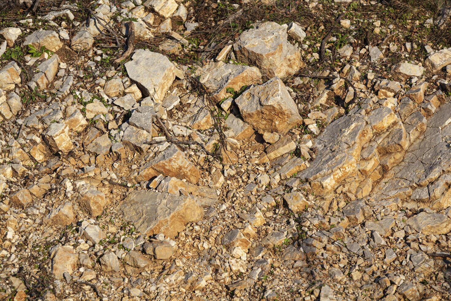 Red rocks of different shapes and sizes on the ground. Orange texture. Background. For text. For banner. Horizontal photo