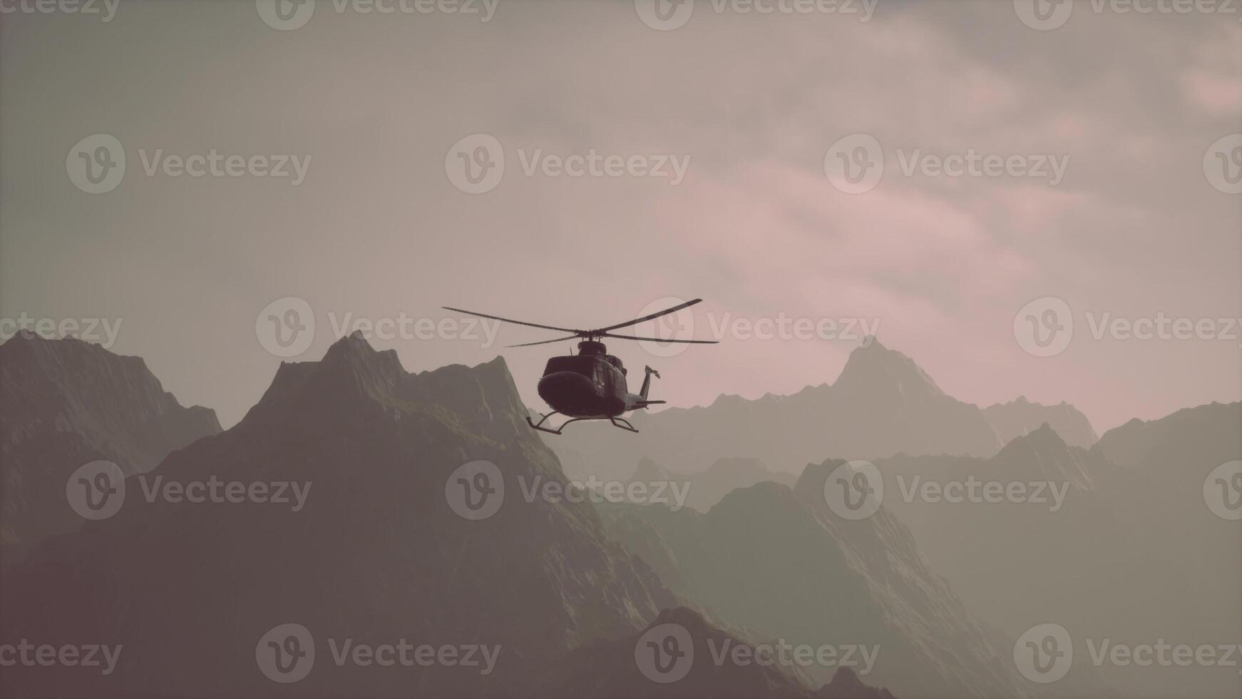 A helicopter is flying over a mountain range photo