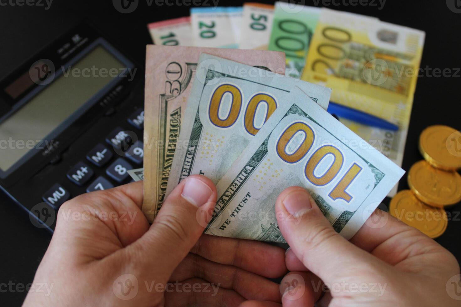 man counting US dollars money with his hand. US banknotes. The paper currency of usa .Calculator in the background. For tax and hike news. raise, tax, minimum wage photo