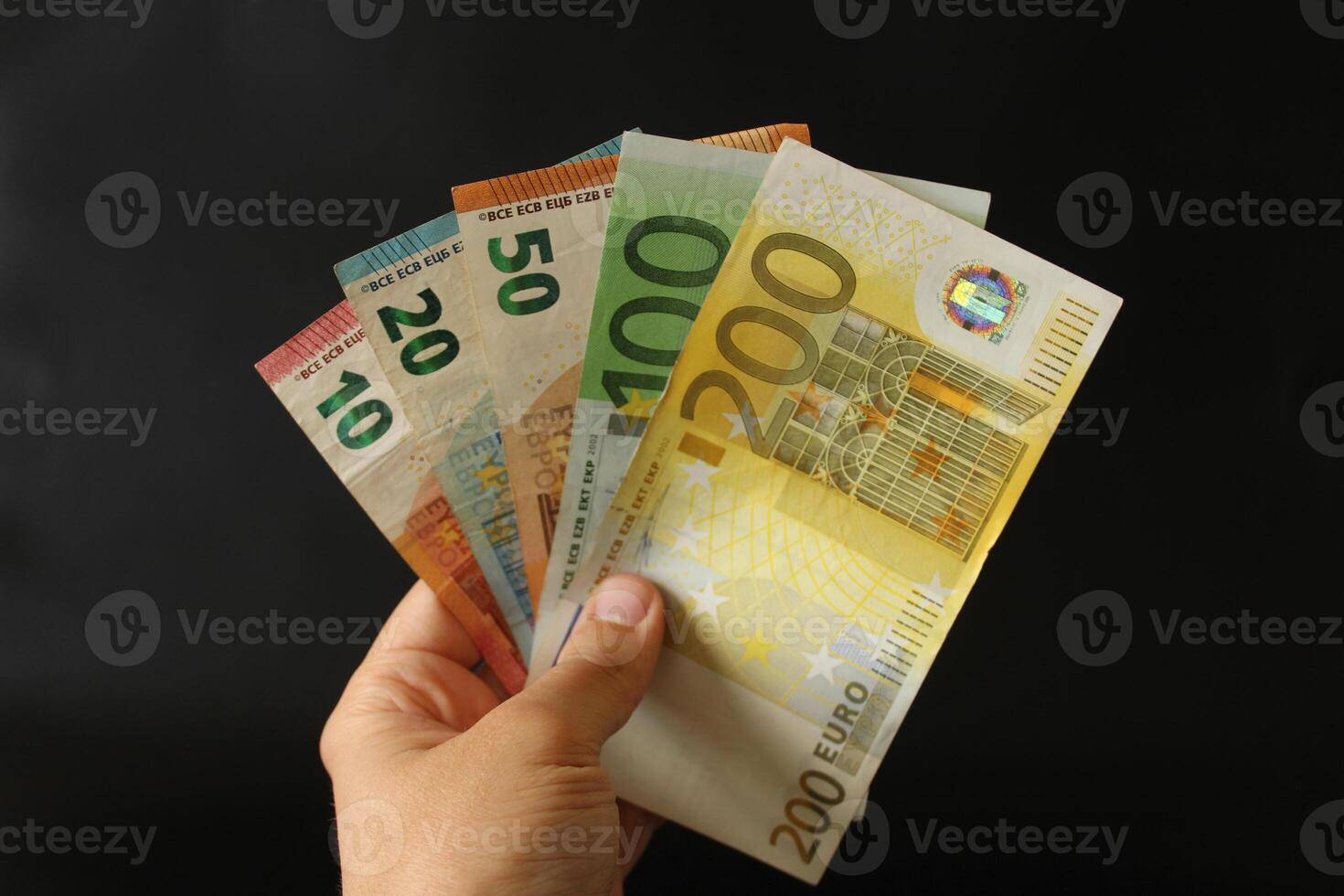 man counting euro money with his hand. euro banknotes. The paper currency of europan union .Calculator in the background. photo