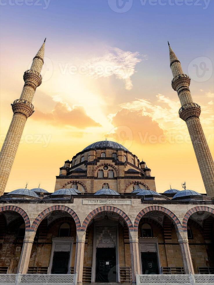 a building with a blue dome and a large building with a sunset in the background. photo