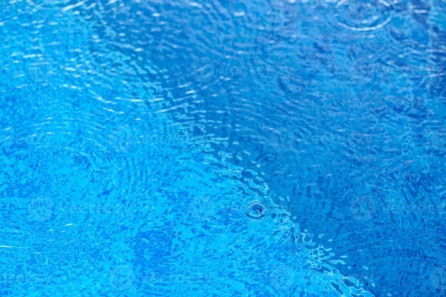De-focused blurred transparent blue colored clear calm water surface texture with splashes and bubbles.8 photo