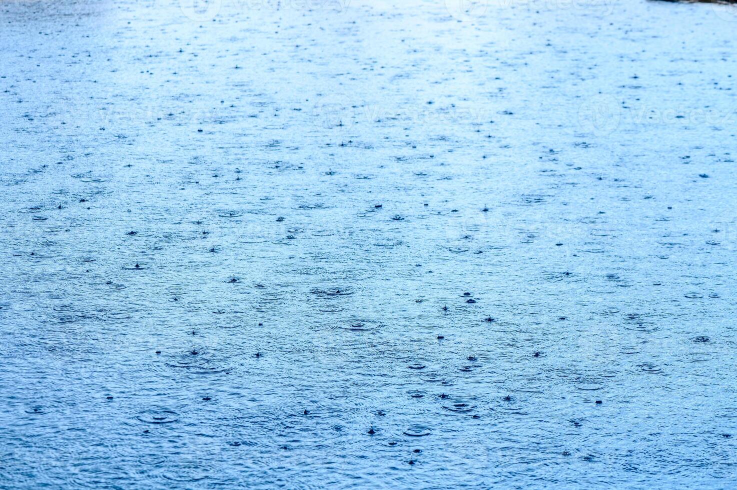 Water blue surface abstract background. Waves and ripples of cosmetic moisturizer with bubbles photo