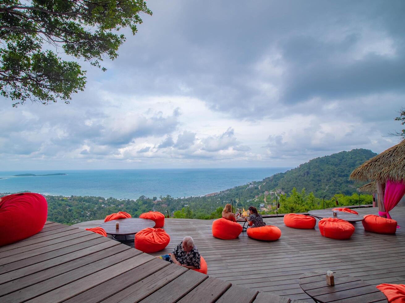 From the restaurant and cafe located on the red-padded cliff, an aerial view of the vivid sea. photo
