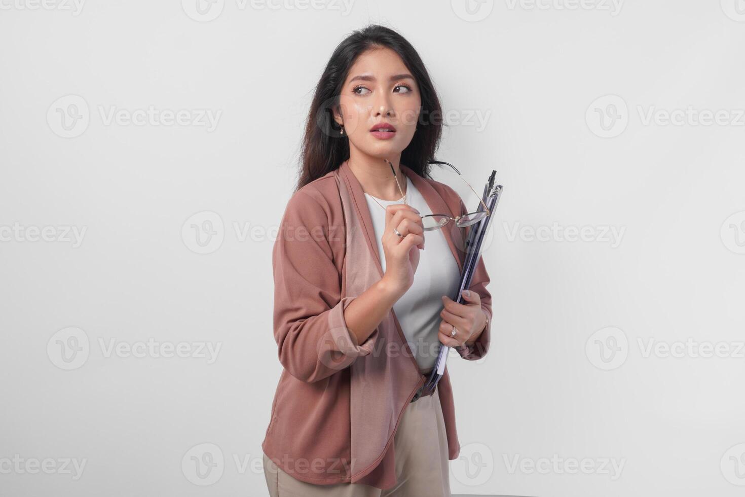 Stylish Asian woman wearing eyeglasses holding document while doing a chic and elegant pose isolated by white background. photo
