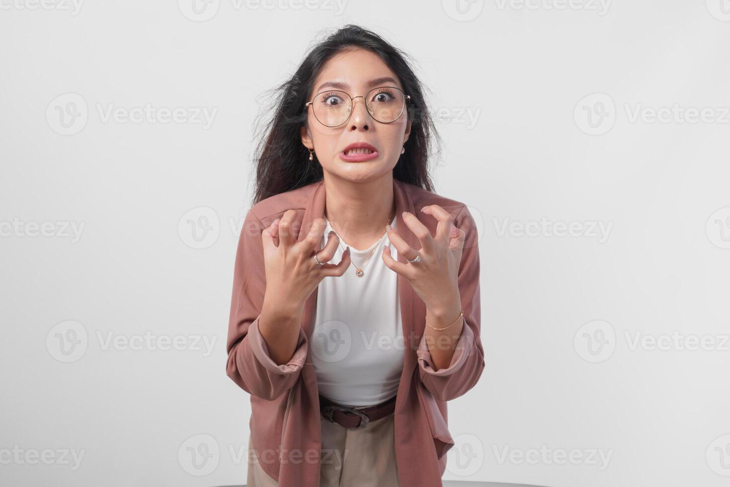 Irritated Asian woman in glasses expressing annoyed, mad, frustrated feelings isolated over white background. photo