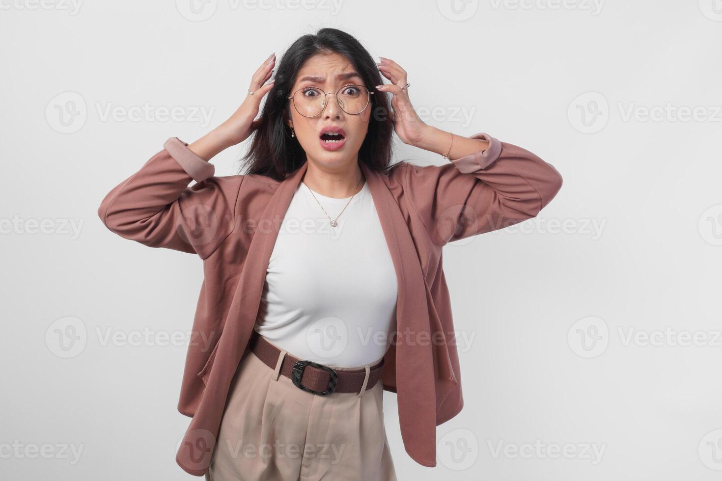 Sad Asian woman wearing eyeglasses looking stressed and depressed or having headache, isolated white background. photo