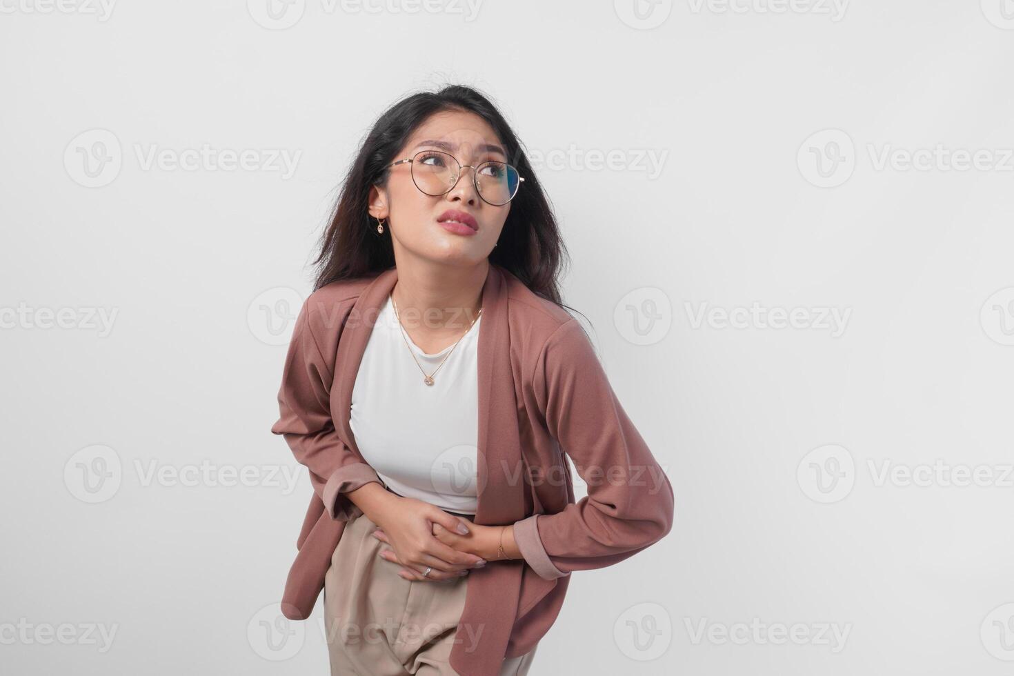 Unwell sick ill young woman placing hand on stomach suffers pain isolated on white background. photo