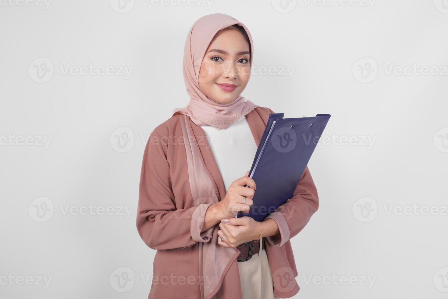 Stylish Asian woman wearing hijab holding document smiling happily isolated by white background. photo