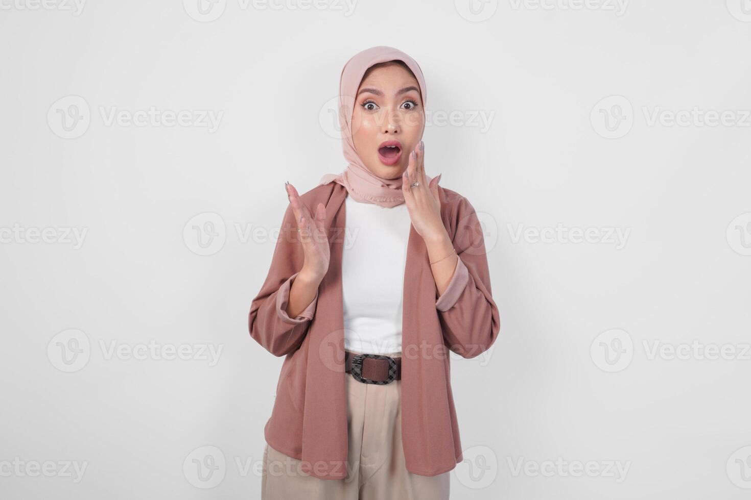 Surprised young Asian Muslim woman wearing hijab with shocked expression isolated on white background. photo