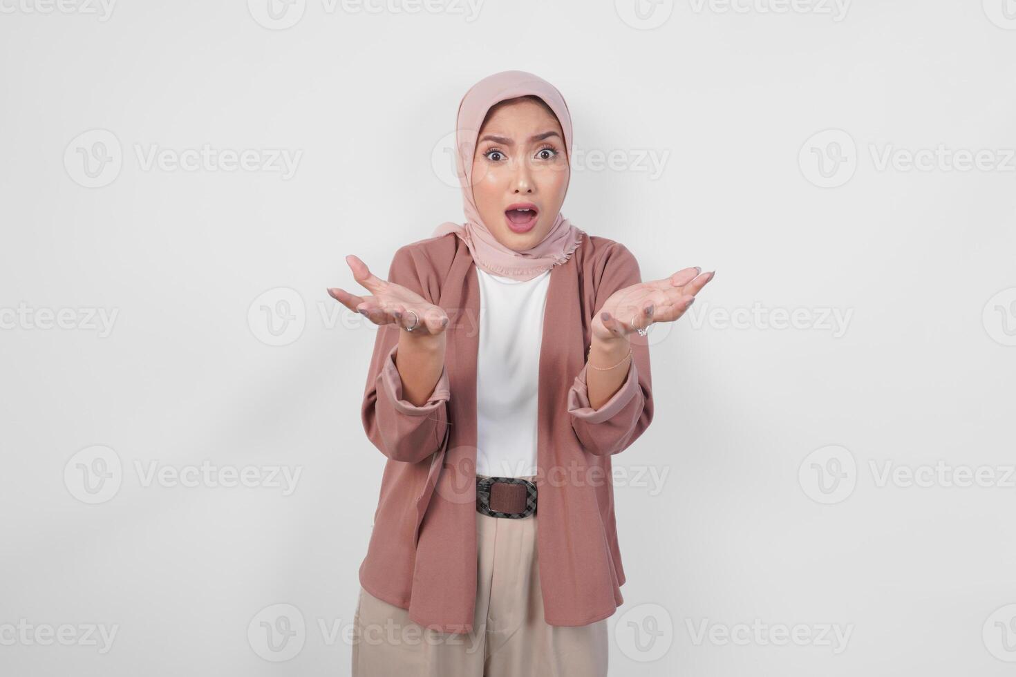Surprised young Asian Muslim woman wearing hijab with shocked expression isolated on white background. photo
