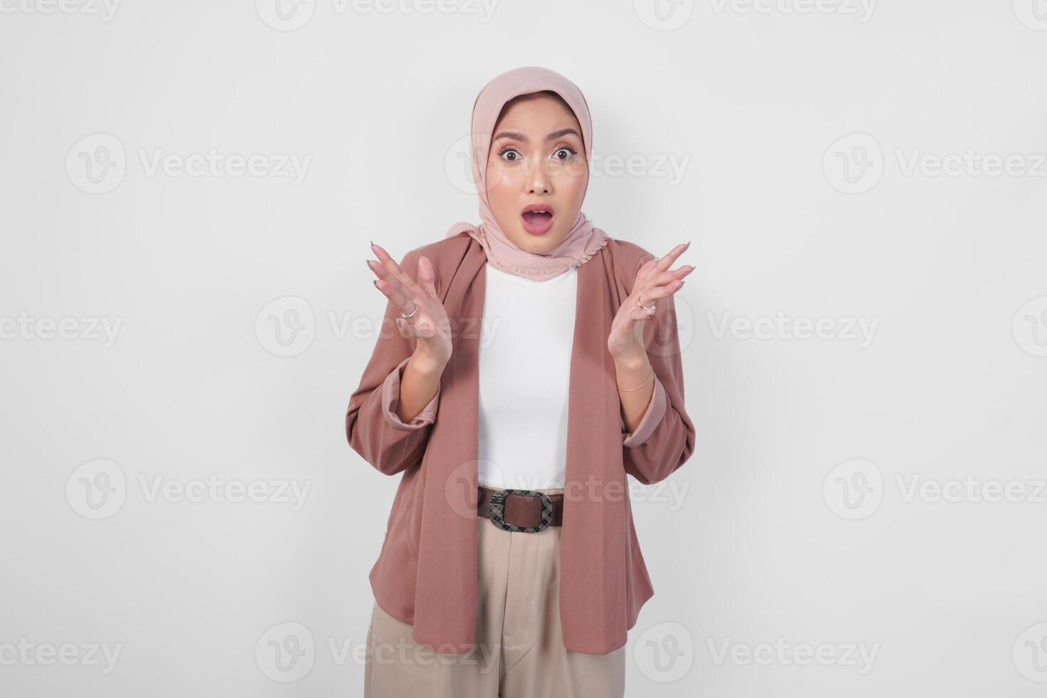 Surprised young Asian Muslim woman wearing hijab with shocked expression isolated on white background. photo