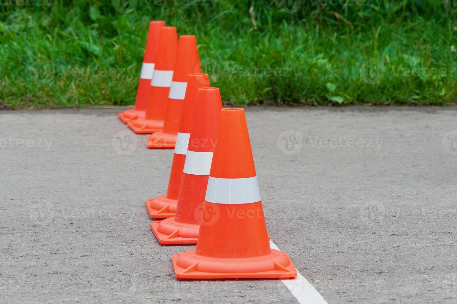 Orange traffic cones standing in a row photo