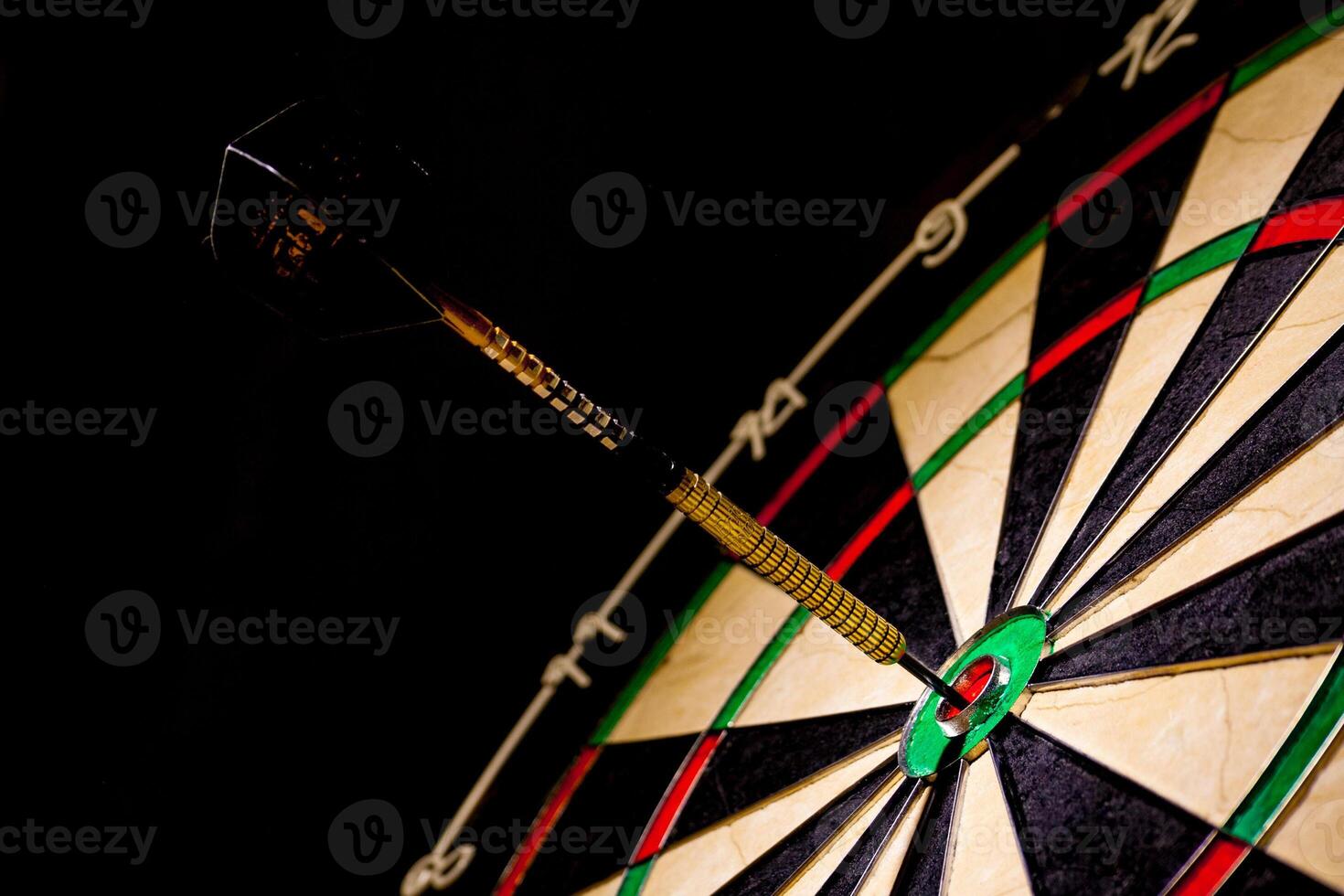 Fragment of target with dart in bullseye photo