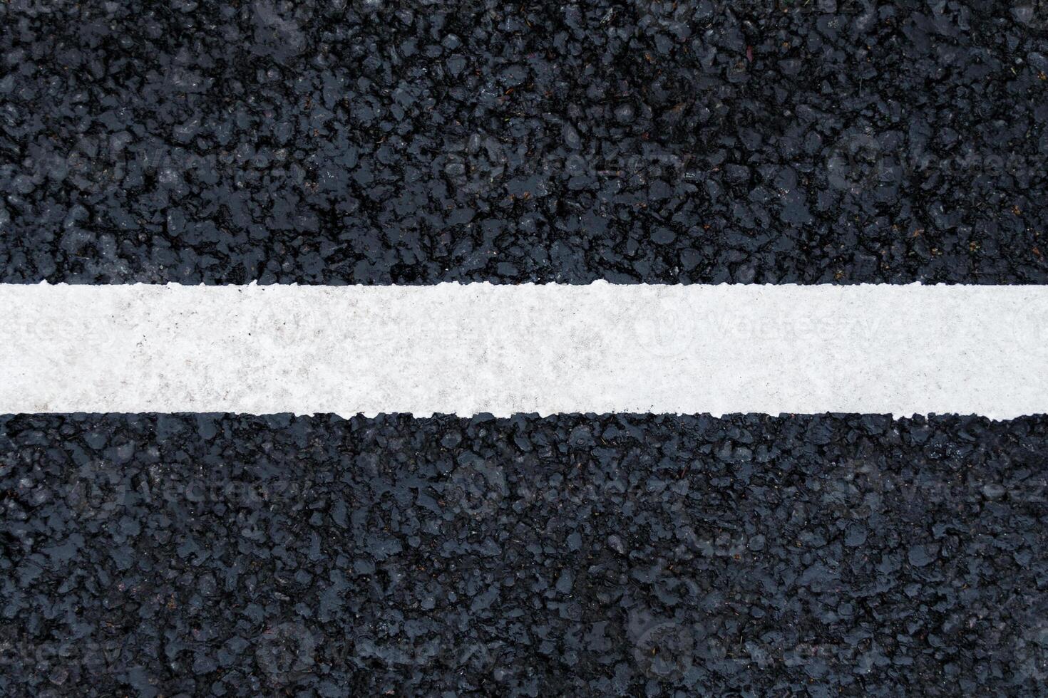 Horizontal white marking line on the asphalt road background, texture, abstract photo