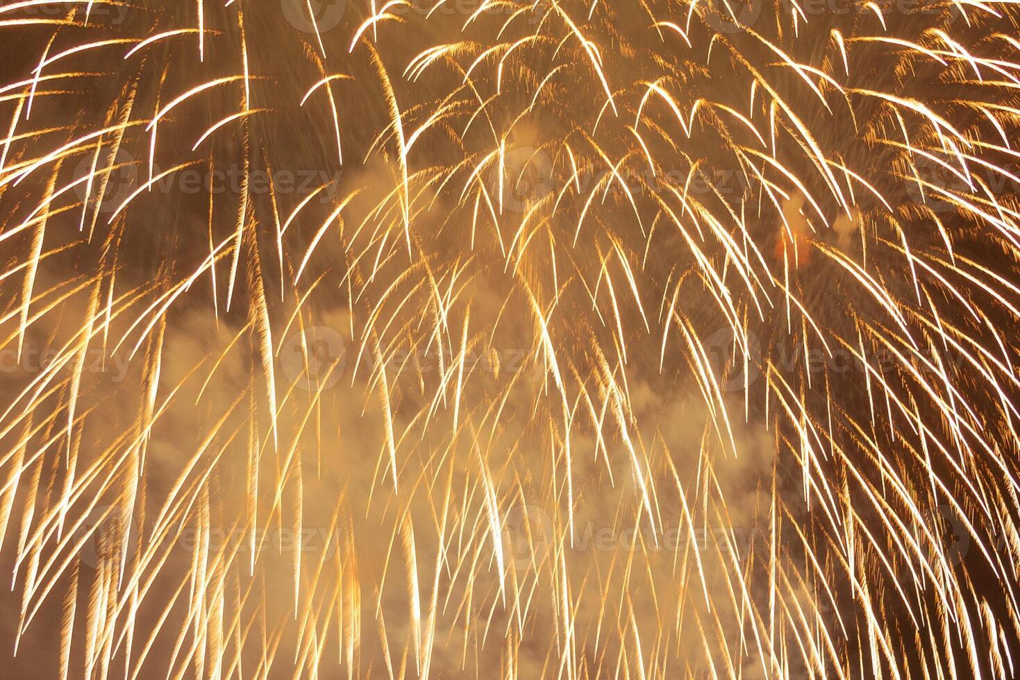 Golden sparks of festive fireworks as background photo