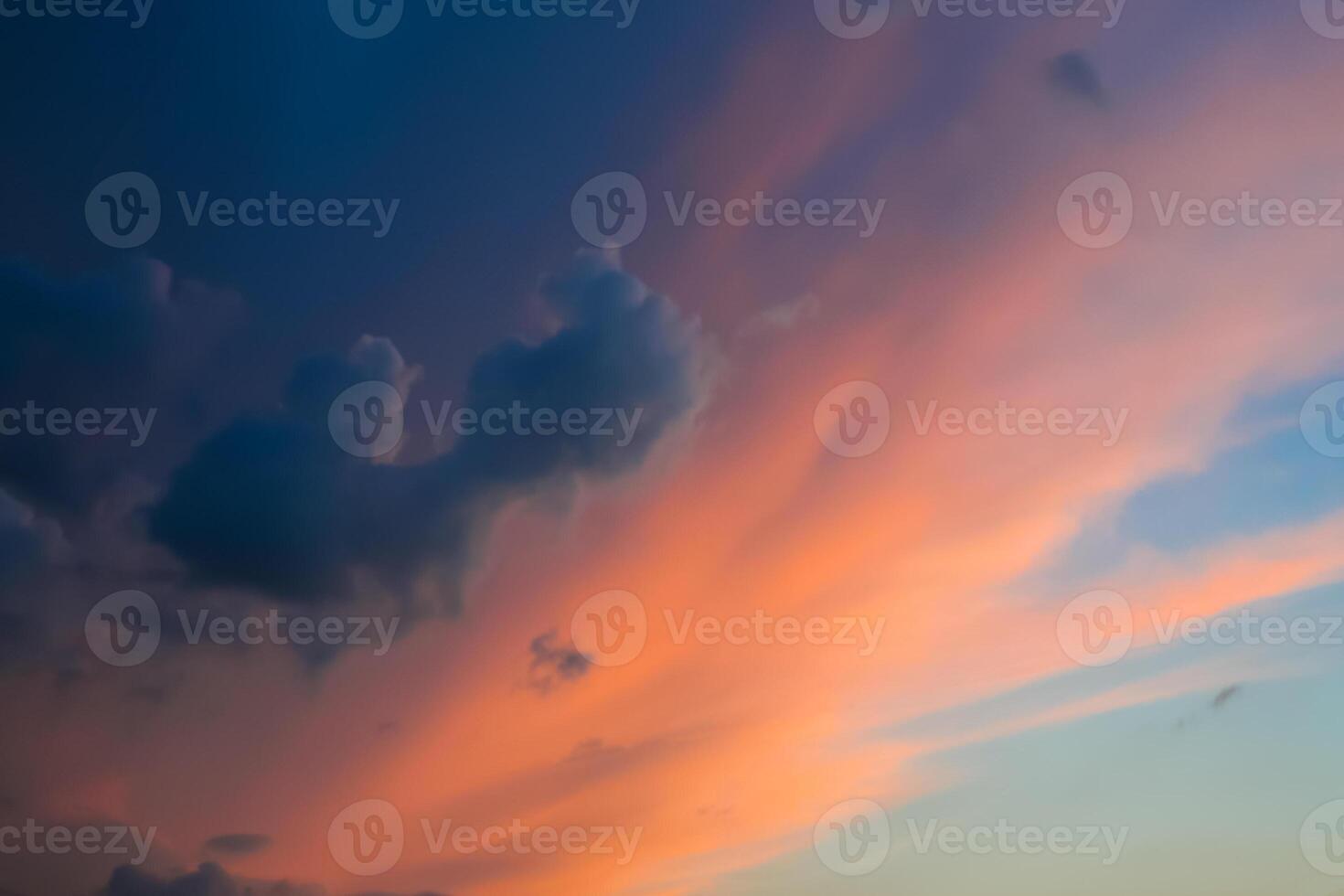 Dramatic view of clouds illuminated by the sun in the evening sky photo